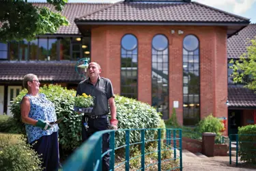 Gardener Laughing With Resident