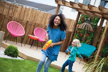 Woman and child playing in garden