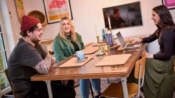 People Sat At Table Talking