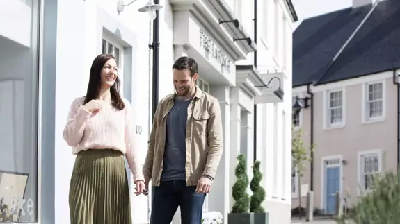 Man And Woman Walking Down The Street