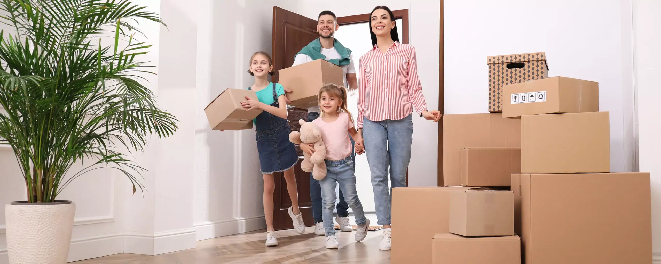 Family Moving Into A Home With Boxes