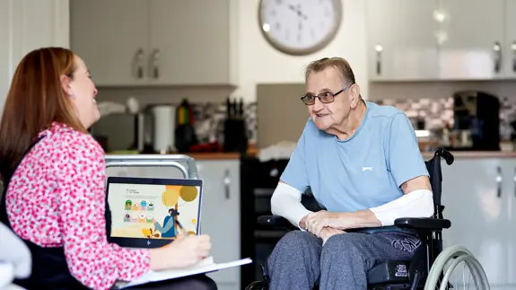 Man In Wheelchair Talking To Other Woman