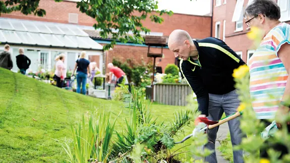 Man And Woman Communal Gardening