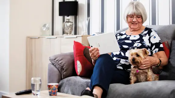 Older Lady On Sofa With Dog